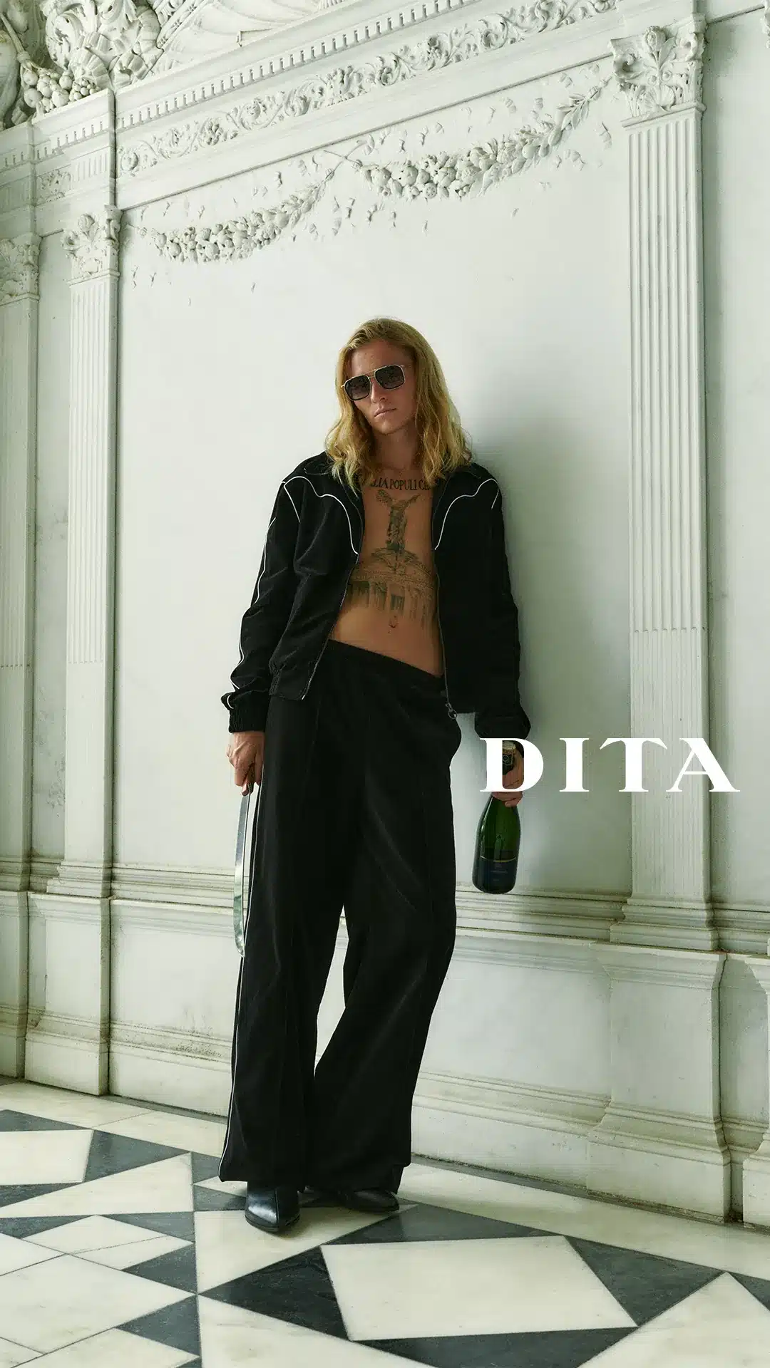Model in DITA aviator sunglasses leaning against a carved marble wall