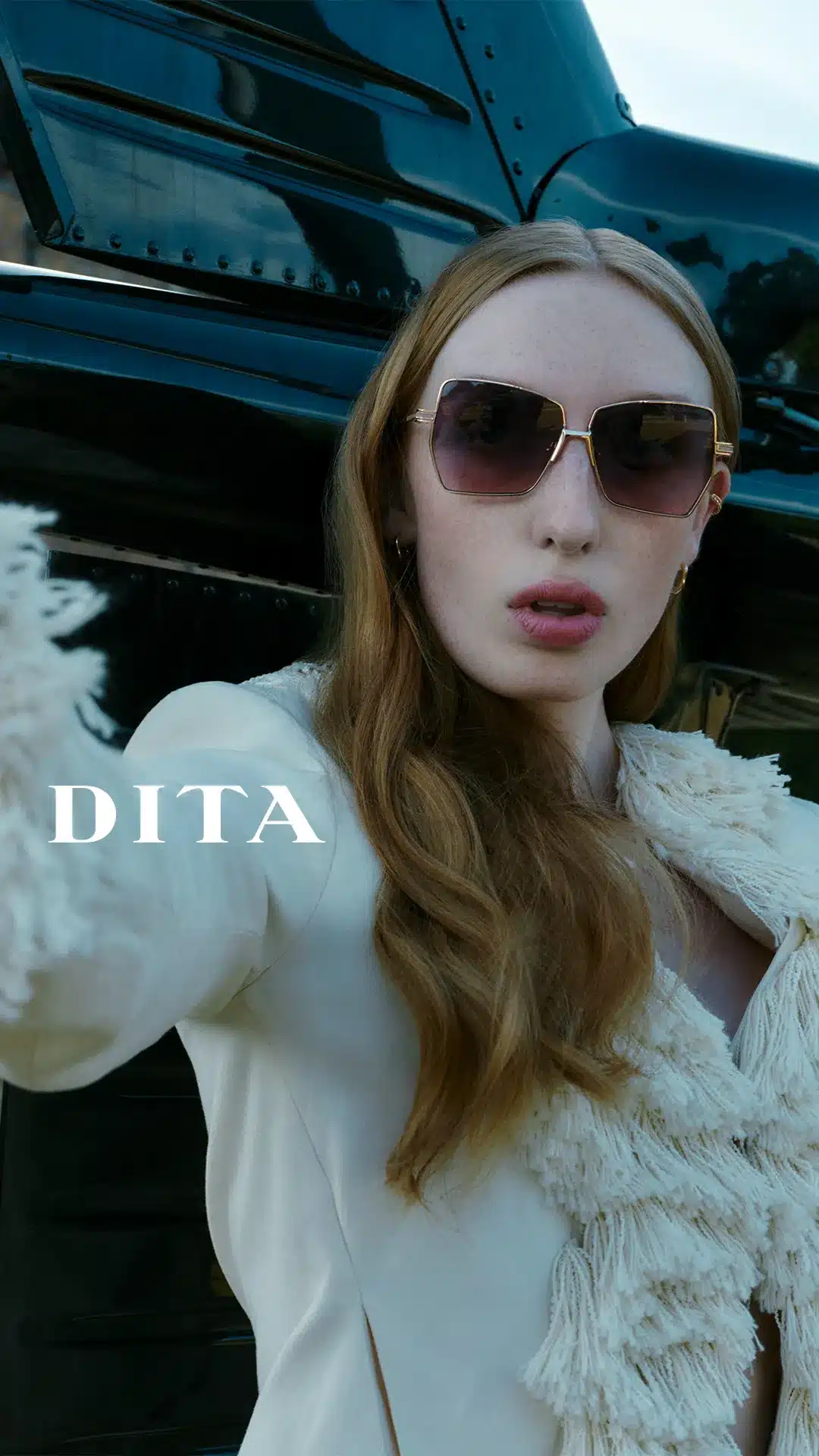 Close-up of a model wearing DITA oversized gold-wire sunglasses with gradient lenses